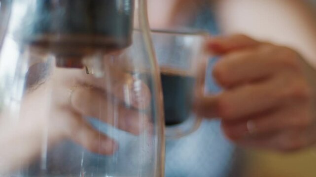 Woman drinks dark pu erh tea from the thermal double wall glass
