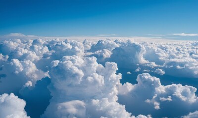 Fototapeta premium Scenic aerial view of fluffy white clouds against a clear blue sky