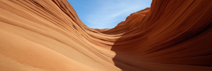A stunning view of sandstone canyon formations, showcasing the intricate texture and colors under the expansive blue sky, inviting awe and deeper appreciation of nature's wonders.