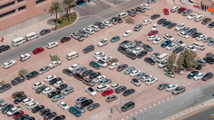 Aerial view full cars at large outdoor parking lots timelapse in Dubai, UAE.
