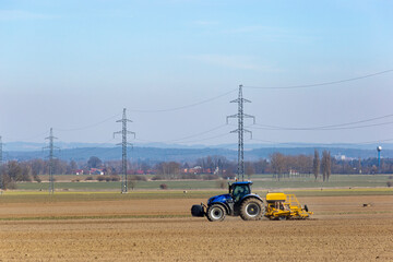 Tractor in a field of the early spring time agricultural activities.