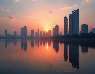 Obraz premium Scenic sunset over Mumbai city skyline reflected in tranquil water. Silhouettes of skyscrapers create picturesque view. Urban landscape reflects sun at dusk. Modern waterside cityscape with sunshine.