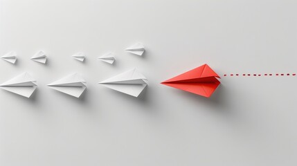 Innovative red paper airplane leads a group of white paper airplanes against a minimalist background