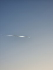 The plane is flying in the clear sky