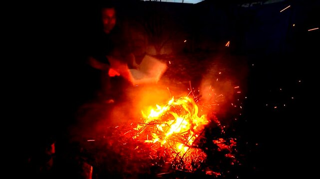 A guy makes fire outside ash danger