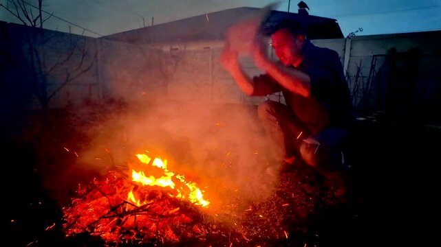 A guy makes fire outside ash danger