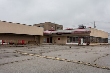 Brown brick building in an abandoned shopping center on overcast day in East St. Louis
