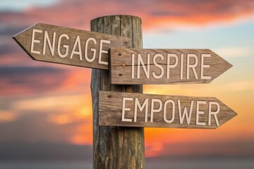 Employee engagement fosters loyalty and deeper workplace involvement concept. Wooden signpost with motivational words against a sunset background.