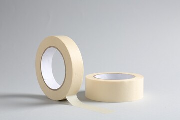 Two masking tapes on grey background, closeup