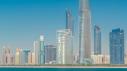 Obraz premium View of high skyscrapers on a corniche in Abu Dhabi stretching alongside the business center timelapse hyperlapse.