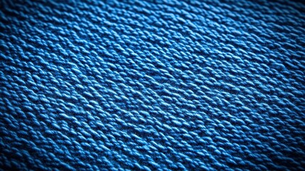 A close-up view of textured blue fabric showcasing intricate patterns and threads, emphasizing its material quality.