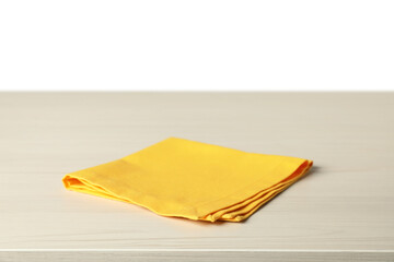 Yellow napkin on light wooden table against white background