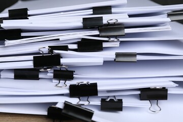 Binder clips with sheets of paper, closeup