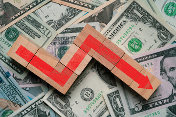 Red down arrow on Usd dollar banknote for United States of America risky economic recession after...
