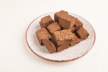 Chocolate marshmallow on white wooden. side view.