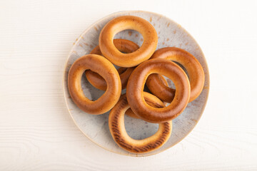 Homemade Ring Bagel on white wooden, top view, copy space.
