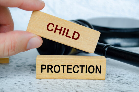 Child Protection text on wooden blocks with lawyer gavel background. Child safeguard concept