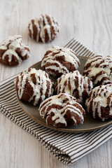 Homemade Profiteroles with Coconut Cream on a Plate, side view.