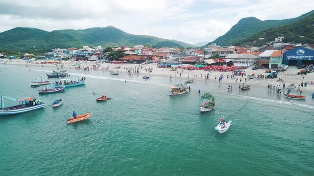 People celebrate the day of Iemanja, or the day of Our Lady of Navigators. Group of people gather on the beach in Brazil and celebrate. Iemanja is a popular Afro-Brazilian deity associated with the