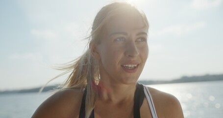 An active woman enjoys an exhilarating outdoor adventure by the picturesque water