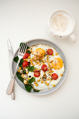 A nutritious and Healthy Breakfast featuring Eggs, fresh Tomatoes, and vibrant Spinach, chickpeas and coffe.