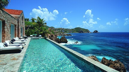 Fototapeta premium Coastal luxury villa with infinity pool overlooking the turquoise ocean