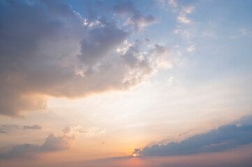 Fototapeta premium sunset / sun rise sky with rays of light shining clouds and sky background and texture