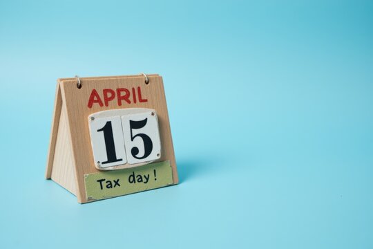 Decorative Desk Calendar Marking Tax Day on April 15 Featuring Bold Numbers and Colorful Artwork Against a Soft Blue Background, Ideal for Tax Reminders and Planning