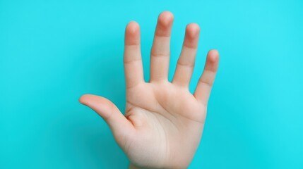 A raised hand shows five fingers extended, set against a vivid blue background. This gesture often signifies a request for attention or a signal to stop