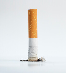 Cigarette butt extinguished on a clean white surface