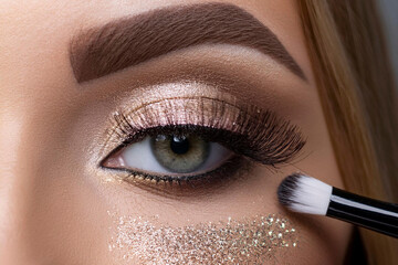 Generative AI beautiful woman girl in beauty salon makeup artist applying evening eye makeup with eye brush, with shimmer eyeshadow