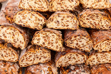 Freshly baked raisin bread with a crunchy crust and a dense filling of sweet raisins displayed at an Italian food fair offering regional handmade baked specialties