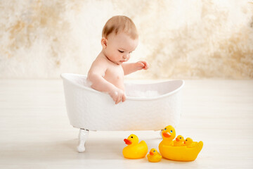 a baby bathes in a bubble bath, a place and space for text, the concept of child hygiene