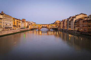 Arno river and famous Ponte Vecchio bridge after sunset. View from Ponte alle Grazie in Florence, Tuscany, Italy 