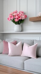 Bright daffodils arranged in a clear vase bring color to a modern living room featuring a comfy grey sofa and soft lighting