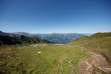 Fototapeta premium Stunning panoramic view from Ahorn mountain in Mayrhofen, Austria showing lush greenery and distant peaks