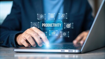 Fototapeta premium Employee engagement enhances productivity and performance concept. Hand using laptop with productivity icons illuminated above screen.