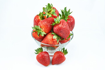 A clear glass bowl filled with fresh, plump strawberries
