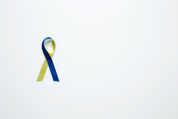 A yellow and blue awareness ribbon, symbolizing World Down Syndrome Day