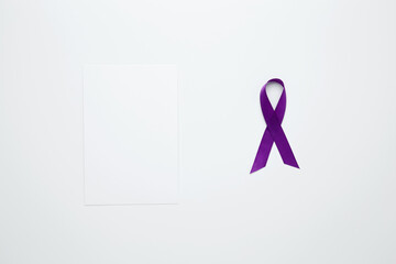 Purple Epilepsy Awareness Day, purple ribbon held, symbol of support. Mock up white paper