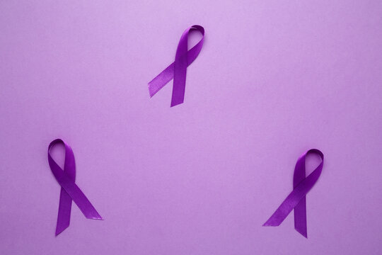 Purple Epilepsy Awareness Day, purple ribbon held, symbol of support - Powered by Adobe