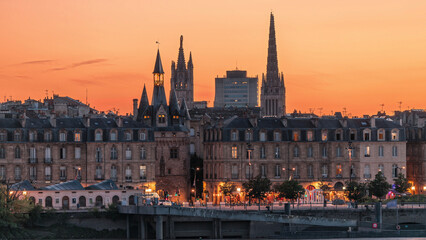 Fototapeta premium Panoramic view of Bordeaux city skyline day to night transition timelapse. France