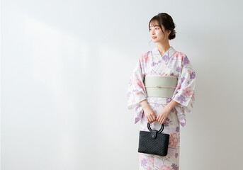 A woman wearing a pastel-colored yukata- traditional attire