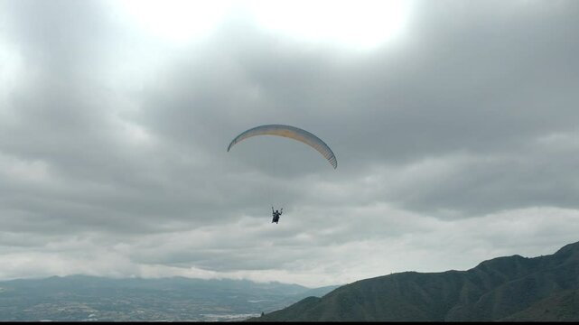 Paragliding hobby flying above the clouds enjoying leisure time couple gift experience extraordinary