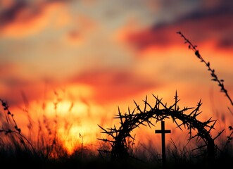 Crown of Thorns and Cross Silhouette Against a Colorful Sunset Backdrop