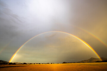 Double rainbow in late afternoon sun in light rain