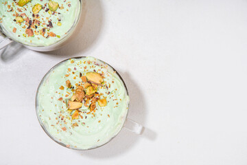 Vegan pistachio milk coffee latte. Iced and hot coffee drinks with plant based whipped pistachio creamer, copy space