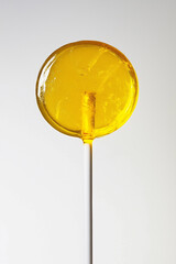Bright Yellow Lollipop on White Stick