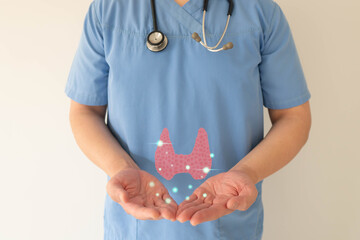 Thyroid gland anatomy on doctor hands. Awareness of thyroid disease such as hyperthyroidism,...