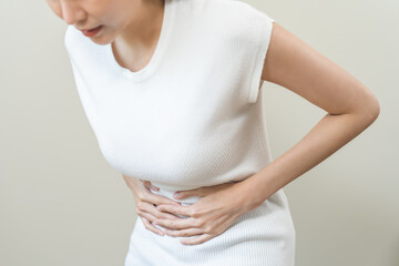 Flatulence asian young woman intolerance hand in stomach ache, suffer from food poisoning,...
